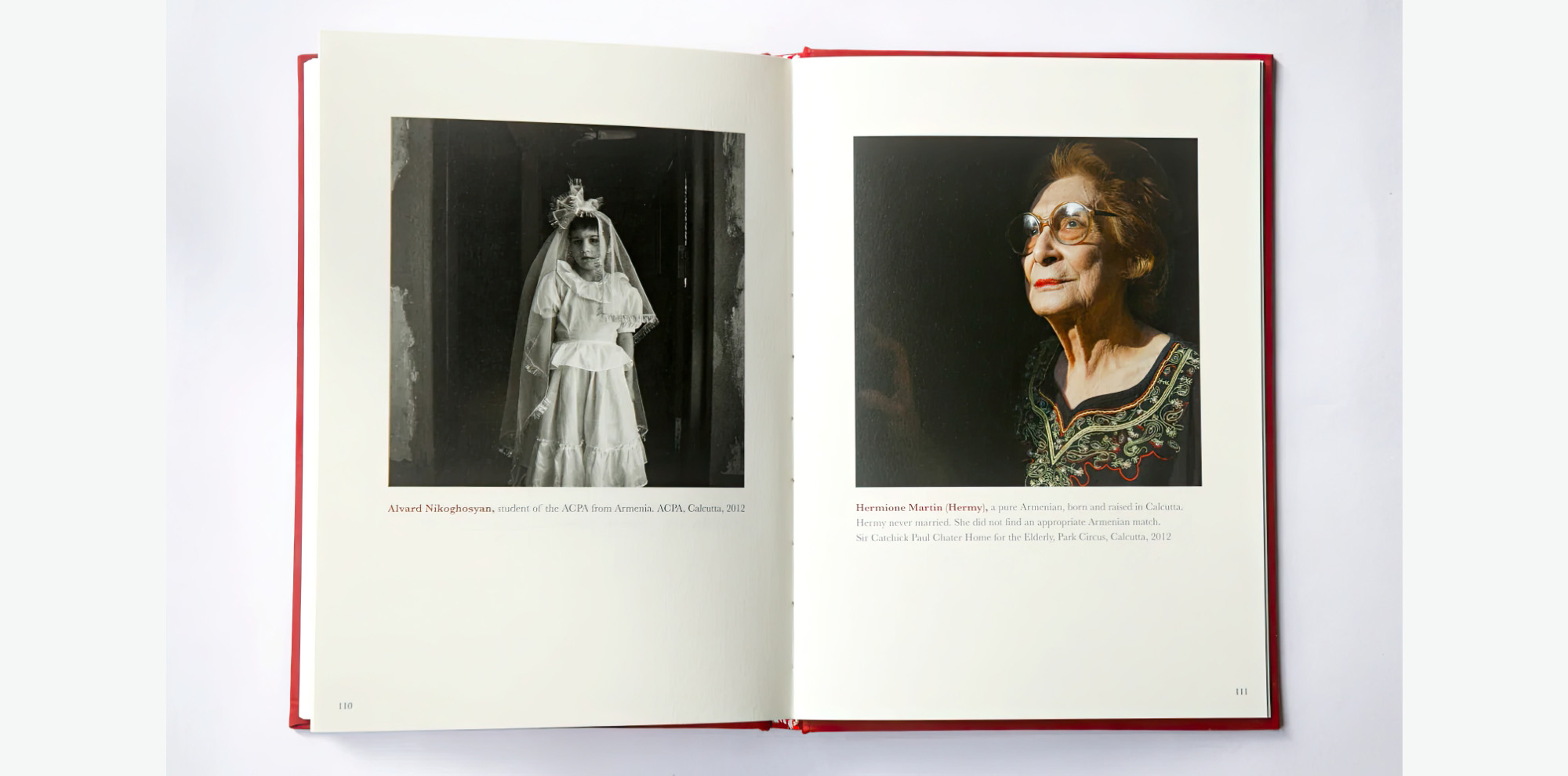 An open book with a photograph of a girl in a white dress and veil and an old woman wearing glasses emerging from the shadows.