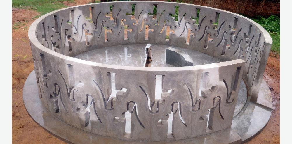 A top view of a circular concrete wall with water pump-shaped holes surrounding a functioning hand-operated water pump.