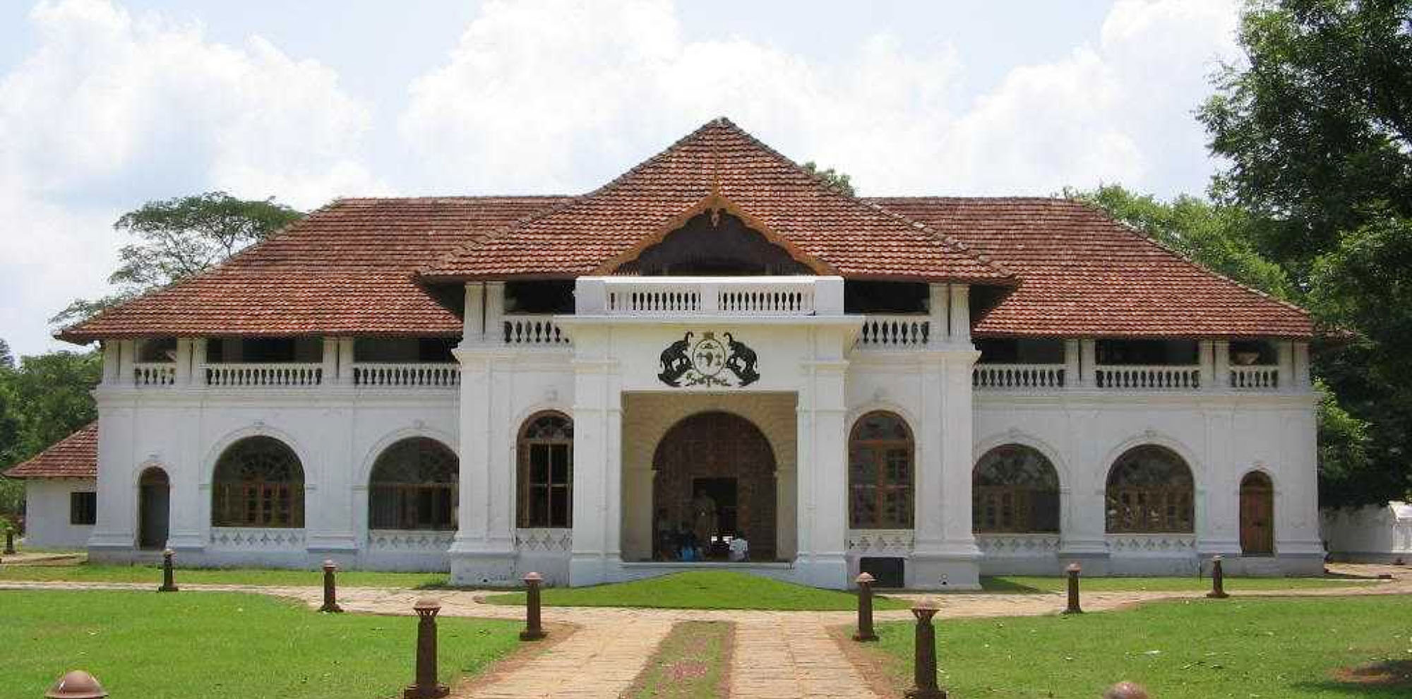 A white building with a tiled sloping roof.
