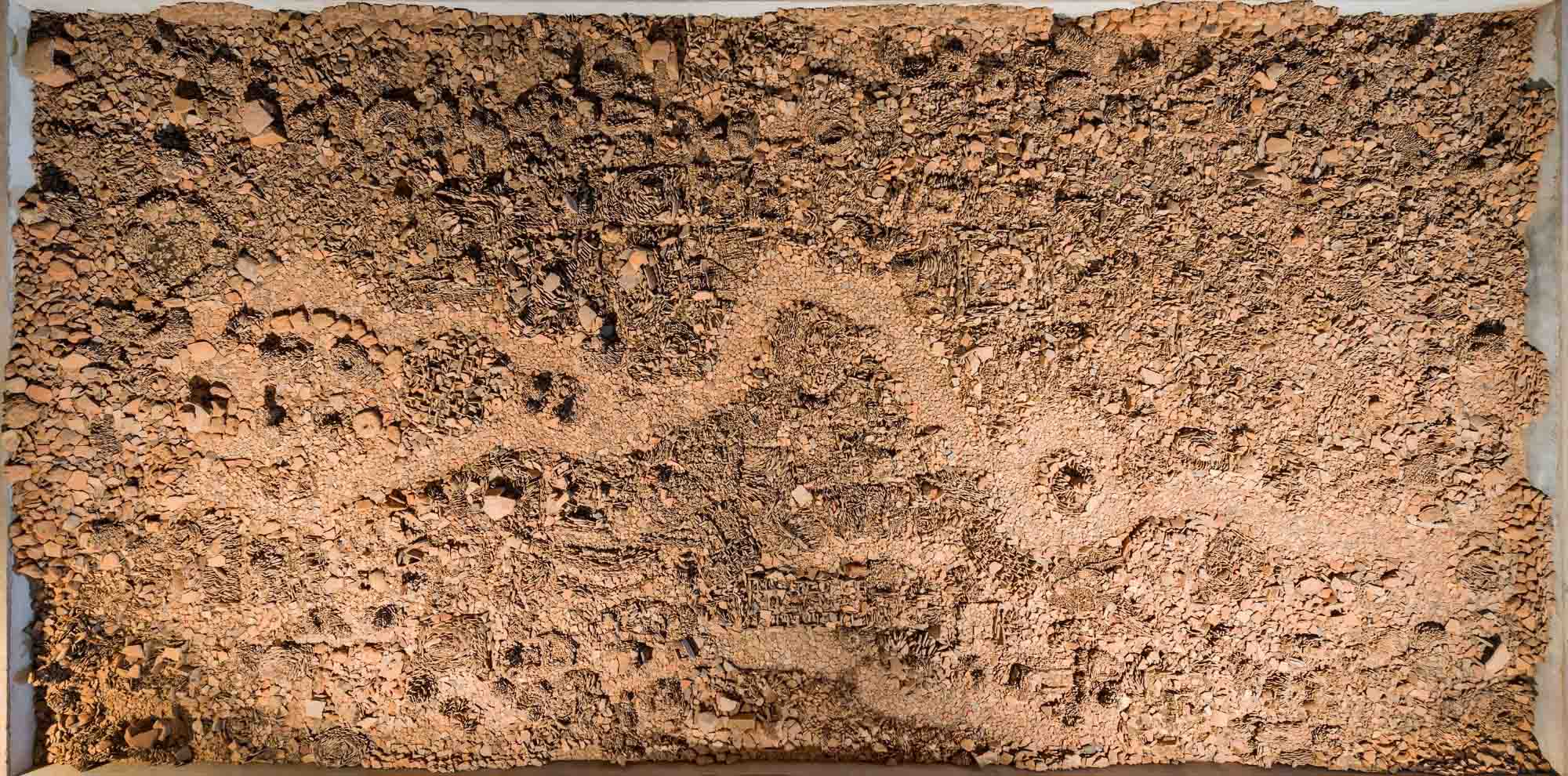 An artwork of mud and stones covering a large area.