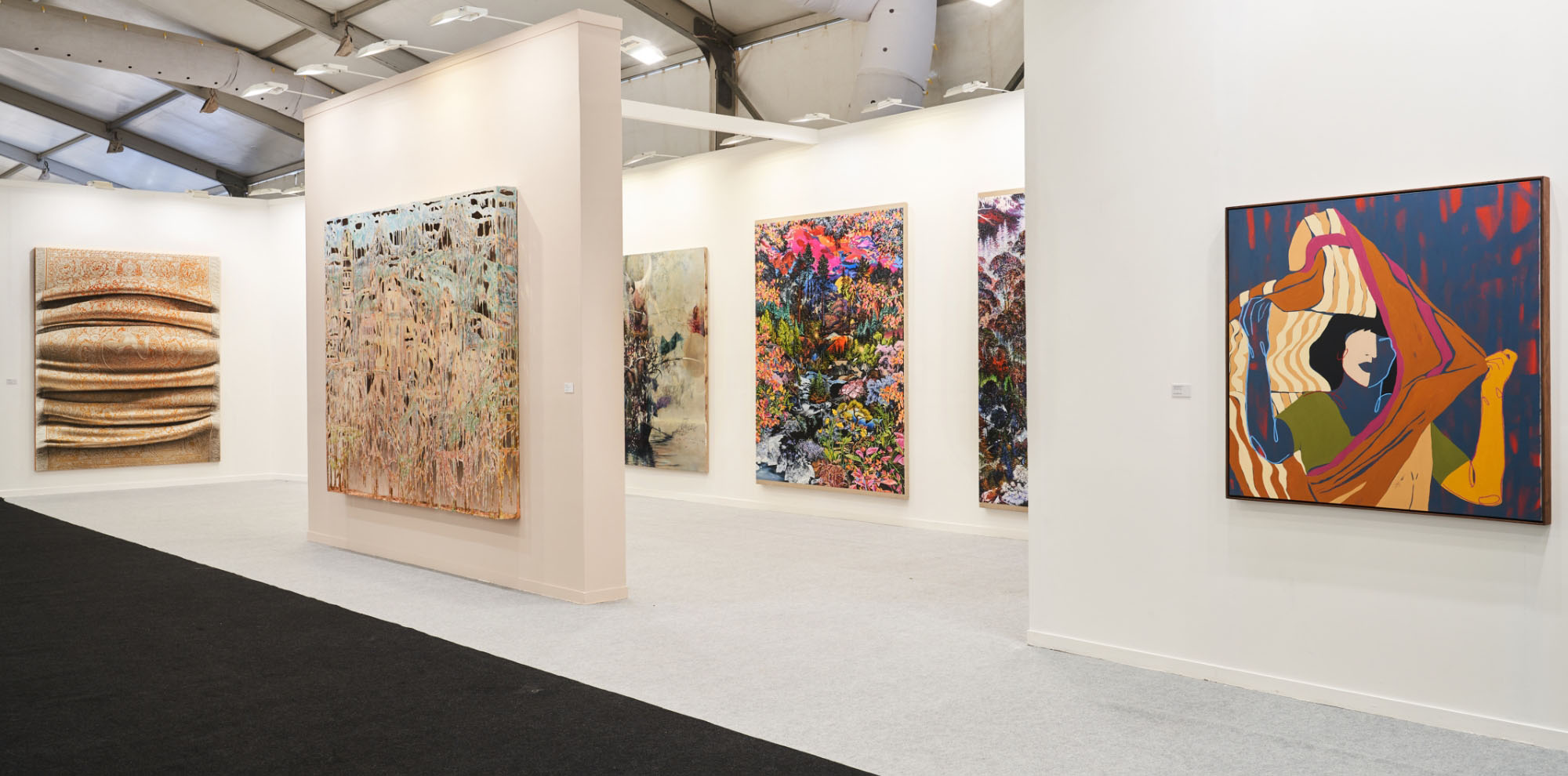 Several large-scale paintings are displayed on different walls of the exhibition space.